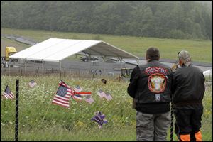Visitors overlook the temporary memorial to Flight 93 in Shanksville, Pa.