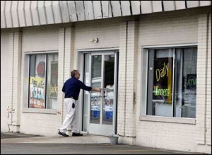 In this photo taken March 23, 2011, an unidentified man enters the Players Club Internet Cafe in Columbus. 