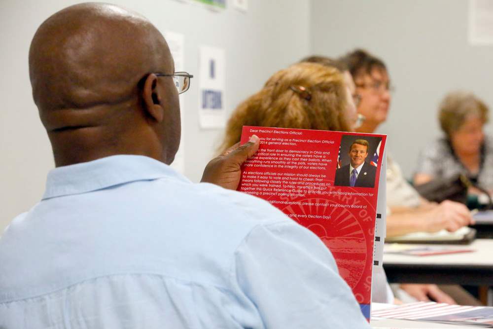 CTY-earlyvote30pElection-s-worker-Andrew-Fuqua-Sr-reads-training-material
