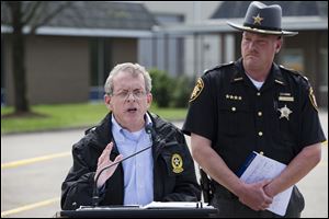 In this April 27, 2016, file photo, Ohio Attorney General Mike DeWine, left, and Pike County Sheriff Charles Reader, right, discuss the slayings of seven adults and a 16-year-old boy from the Rhoden family found shot April 22, 2016.
