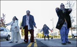Sylvia LaCourse, Jeff LaCourse, Brenda Johnson, and William Johnson walk like zombies down Adams St. during last year's Zombie Crawl. This year's will be held Oct. 21.