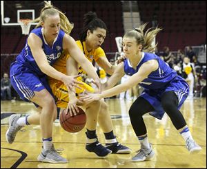 Toledo's Jay-Ann Bravo-Harriott, center, fights Buffalo's Katherine Ups, left, and Stephanie Reid, right, for a loose ball during the during the MAC Tournament last season.