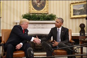 President Barack Obama shakes hands with then-President-elect Donald Trump in the Oval Office of the White House in Washington. 