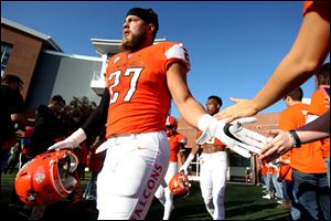 Bowling Green's Nate Locke gives fans high fives before a game against South Dakota.