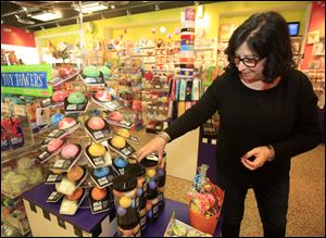 Molly Fitzpatrick shows bath bombs that have surprises inside at Learning Express Toys at The Shops at Fallen Timbers in Maumee.
