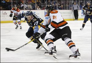 Toledo Walleye player Beau Schmitz defends against Fort Wayne Komets player Kyle Thomas during the ECHL playoffs last season. The Komets have turned the tables on Toledo this season.