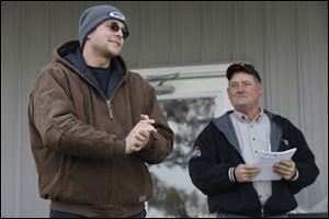 Dairy farmer Willem Van Rooijen, left, fields questions about his farm's operation as Jim Carter, District Technician with the Ohio Department of Agriculture's Soil and Water Conservation Division, listens during a tour of Naomi Dairy Tuesday in Cygnet.