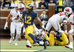 Michigan's Chris Evans picks up yardage against Wisconsin during last year's game in Ann Arbor. The Wolverines are in Madison Saturday, trying to derail the Badgers' quest for a perfect season.