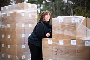 Linda Greene, founder and leader of Impact With Hope, stands with a shipment of diapers and other personal items ready to be delievered to Puerto Rico while working at the distribution center on November 15, 2017.