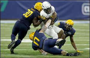 Toledo's Ja'Wuan Woodley (30) and Tyler Taafe bring down Akron quarterback Kato Nelson during the MAC Championship game in Detroit. Toledo will face Appalachian State in the Dollar General Bowl in Mobile, Alabama.
