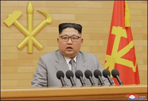 In this photo provided by the North Korean government, North Korean leader Kim Jong Un delivers his New Year's speech at an undisclosed place in North Korea.
