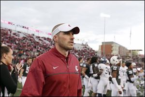Washington State defensive coordinator Alex Grinch walks on the field after a game against Nevada in Pullman, Wash., Sept. 23, 2017. Grinch has been hired by Ohio State.