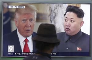 A man watches a TV screen showing U.S. President Donald Trump and North Korean leader Kim Jong Un during a news program at the Seoul Railway Station in Seoul, South Korea. 
