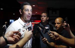 Dan Enos speaks to members of the media as the offensive coordinator at Arkansas in 2015. Enos will be paid $150,000 next season as Michigan's receivers coach.