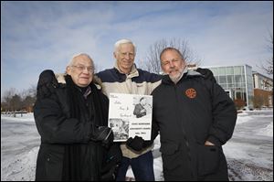 Alfred Cohoe, left, Monty Siekerman, and Terry Keiser pose for a photograph with a recording of the speech Dr. Martin Luther King Jr. gave at Ohio Northern University.