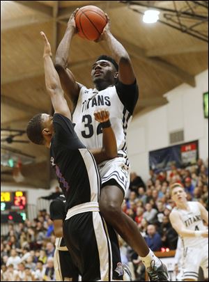St. John's Jesuit's Vincent Williams, Jr. drives into St. Francis de Sales' Tayler McNeal to score 2 of his 35 points Friday night.