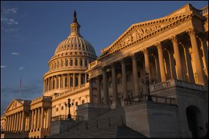 The morning sun illuminates the U.S. Capitol in Washington.