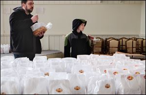Parker Clifton, 11, and his father, Chris Clifton, of Temperance, Michigan, selecting paczkis and a Polish coffee cake in 2016.