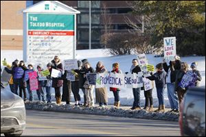 Protesters gather on Monroe Street to call on ProMedica and St. Luke's Hospital to sign a transfer agreement with Capital Care Network, Toledo's last abortion clinic.