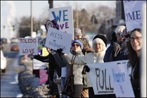 Abortion rights protesters gather on Monroe Street during an event near ProMedica Toledo Hospital to call on ProMedica and St. Luke's Hospital to sign a transfer agreement with Capital Care Network on Monday, Feb.12, 2018.