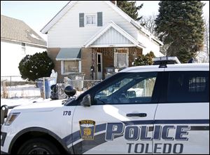 Toledo police officers and the Toledo Area Humane Society follow up on an animal welfare complaint on the 3000 block of Chase Street in Toledo on Monday, February 12, 2018. 
