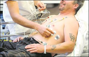 A doctor performs an electrocardiogram on a patient.