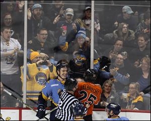 Toledo Walleye center Connor Crisp mixes it up  Kansas City Mavericks defender Tyler Elbrecht during Saturday's game at the Huntington Center. Crisp, who scored 3 goals in the game, was injured in a massive third period brawl. 