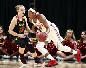 Ohio State guard Sierra Calhoun, right, dribbles around Maryland guard Kristen Confroy during the Big Ten tournament championship game Sunday.