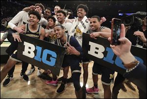 Michigan players celebrate after beating Purdue 75-66 to win the NCAA Big Ten Conference tournament championship college basketball game, Sunday, March 4, 2018, in New York. 