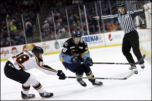 Quad City's Travis Armstrong (88) and Toledo's Mike Borkowski race to the puck.