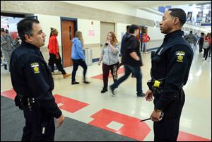 School resource officer Rick Trevino of the Toledo Police Department, left, on his last day on the job at Bowsher High School February 23, 2018. Trevino moved to Waite High School, and was training officer Jeron Ellis, right, to take over at Bowsher.