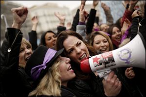 Women shout slogans during a protest at the Sol square during the International Women's Day in Madrid, Thursday, March 8, 2018. 