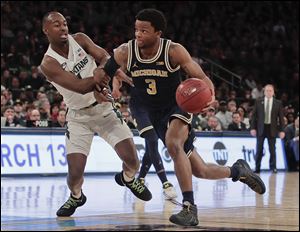 Michigan guard Zavier Simpson drives down the floor during one of the Wolverines two double-digit wins over Michigan State this season. The NCAA Tournament committee placed MSU in Detroit to open the tournament and send Michigan to Wichita.