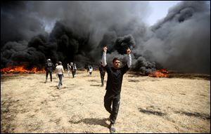 Palestinian protesters burn tires during clashes with Israeli troops along Gaza's border with Israel, east of Khan Younis, Gaza Strip.