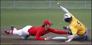 Central Catholic's Jase Bowen tags out Clay's Jack Winckowski during baseball game at Mercy Field in Toledo. 