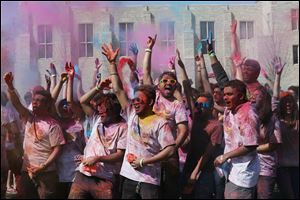 Students toss colored powder into the air in celebration of the Hindu festival of Holi at the University of Toledo in 2015. This year's Holi Toledo at UT takes place Thursday afternoon.