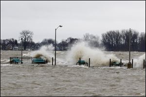 Waves break on the pier in Luna Pier, Mich. Sunday, April 15, 2018.