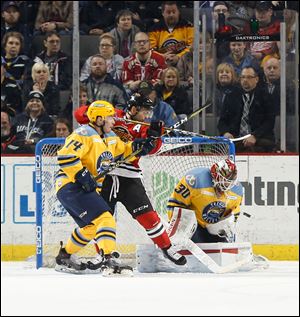 Toledo goalie Pat Nagle makes a stop on a shot by Matt Rupert of the Indy Fuel.