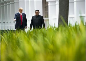 President Trump and Kim Jong Un of North Korea take a walk after their lunch on Sentosa Island in Singapore.