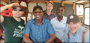With a Kenyan colleague (second from right) aboard a research vessel are, left to right, Timothy Davis, Kefa Otiso, George Bullerjahn and Michael McKay.