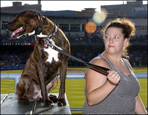 Miranda Phillips, of Deshler, Ohio, attends the game with Daisy, her 4-year-old pit bull.