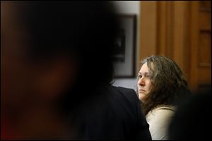 Angie Walker looks at her attorney during her trial at Lucas County Common Pleas Court on Monday, July 9, 2018. 