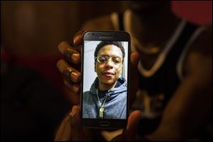 In this file photo, Tre'Von Richardson, 24, shows a recent photo of his brother Lamar Richardson.