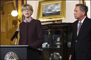 Judge Mary DeGenaro accepts her appointment as a new Ohio Supreme Court justice accompanied by Gov. John Kasich, who announced the selection, on Jan. 25.