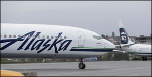 In this Friday, April 13, 2018 file photo an Alaska Airlines plane taxis Friday, April 13, 2018, at the Seattle-Tacoma International Airport in Seattle. 