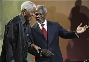 In this July, 2007 photo Nelson Mandela and former United Nations Secretary General Kofi Annan arrive together at the 5th Nelson Mandela Annual Lecture, held at the Linder Auditorium in Johannesburg, South Africa.
