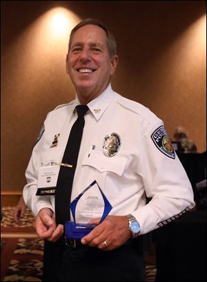 Chief Brad Weis, with the Genoa Police Department, holds his Career Achievement Award, during The Law Enforcement Officer Hall Of Fame 2018 Induction Ceremony at the Pinnacle on Thursday.