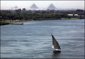 A boat sails along the river Nile in Cairo. A trench around the temple of Kom Ombo in Egypt has rerouted irrigation waters to the Nile, protecting ancient artifacts found in the temple.